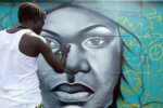 Dakar, Senegal, Africa, May 2025, graffiti artists on a wall along the highway leading to Dakar