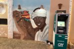 Aswan, Egypt – September 14, 2025: Colorful mural of a smiling Nubian man beside a decorated camel pain